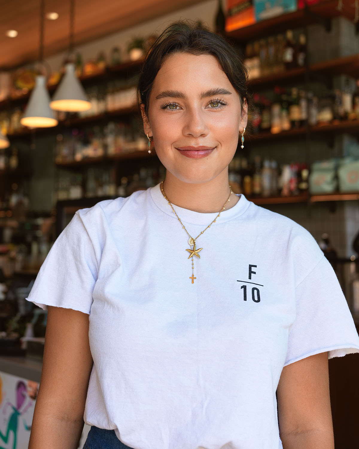 Environmental headshot of a young woman in a coffee shop in Oceanside, California — Headshots by Guffy, San Diego