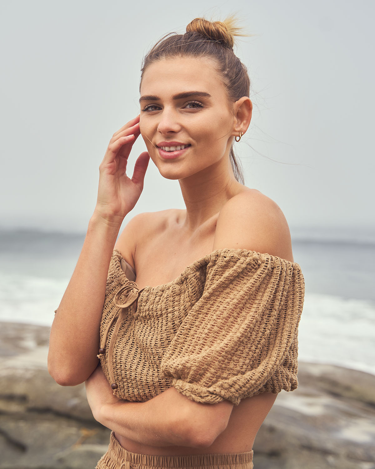 Environmental headshot of a woman smiling warmly with ocean backdrop in San Diego — Headshots by Guffy, San Diego