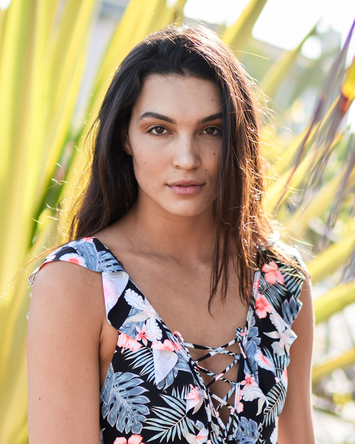Environmental headshot of a woman in front of tropical foliage in San Diego — Headshots by Guffy, San Diego