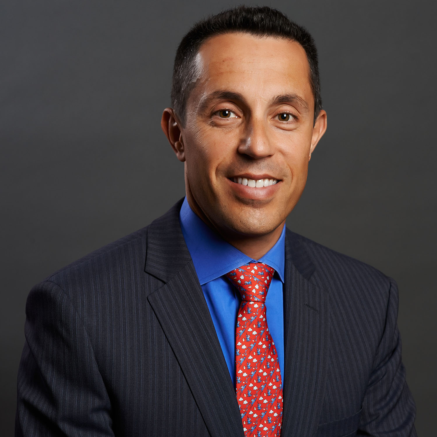 Executive headshot of a man against a gray gradient background — Headshots by Guffy, San Diego