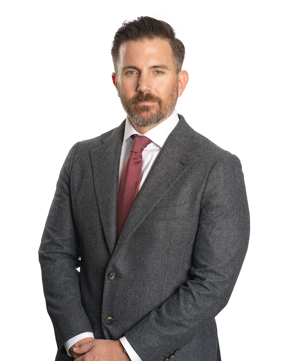 Executive headshot of a man in a charcoal suit against a white background — Headshots by Guffy, San Diego